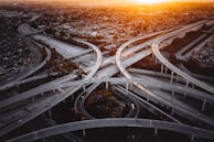 Sunset view of a highway interchange in the Southeast, showcasing the network of lanes served by Logistics USA.