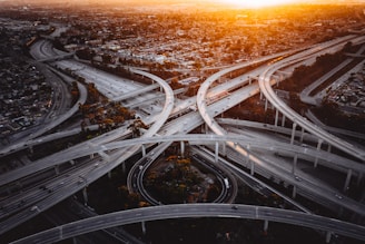Sunset view of a highway interchange in the Southeast, showcasing the network of lanes served by Logistics USA.
