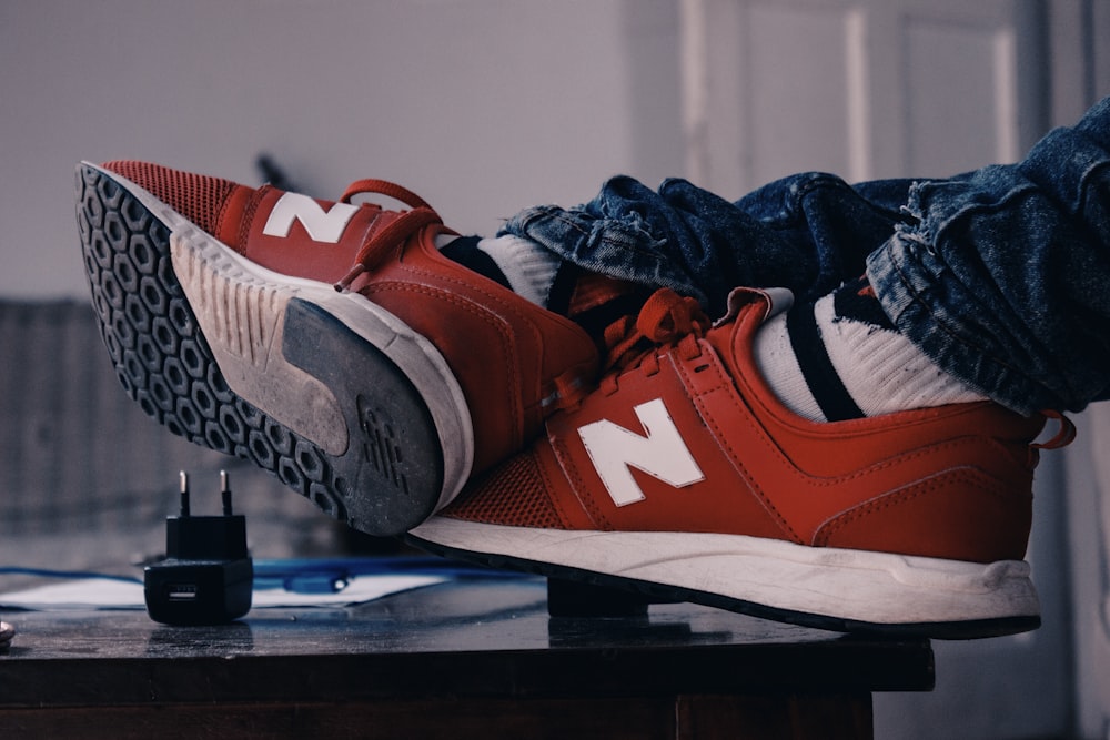 Person wearing red-and-white New Balance running shoes photo – Free Brown  Image on Unsplash