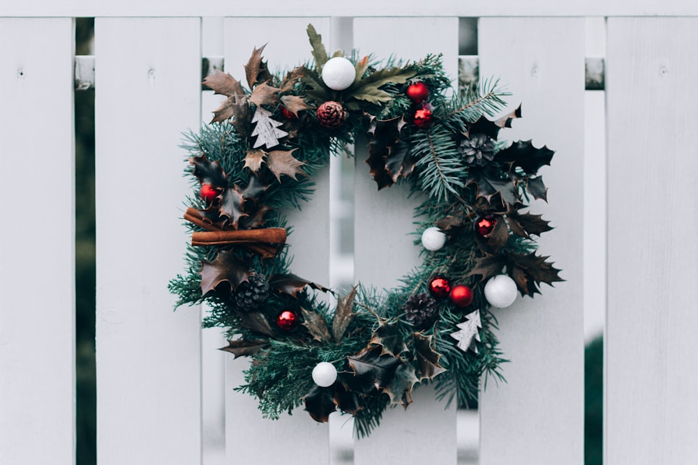 green and white Christmas wreath on wall