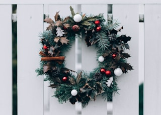 green and white Christmas wreath on wall