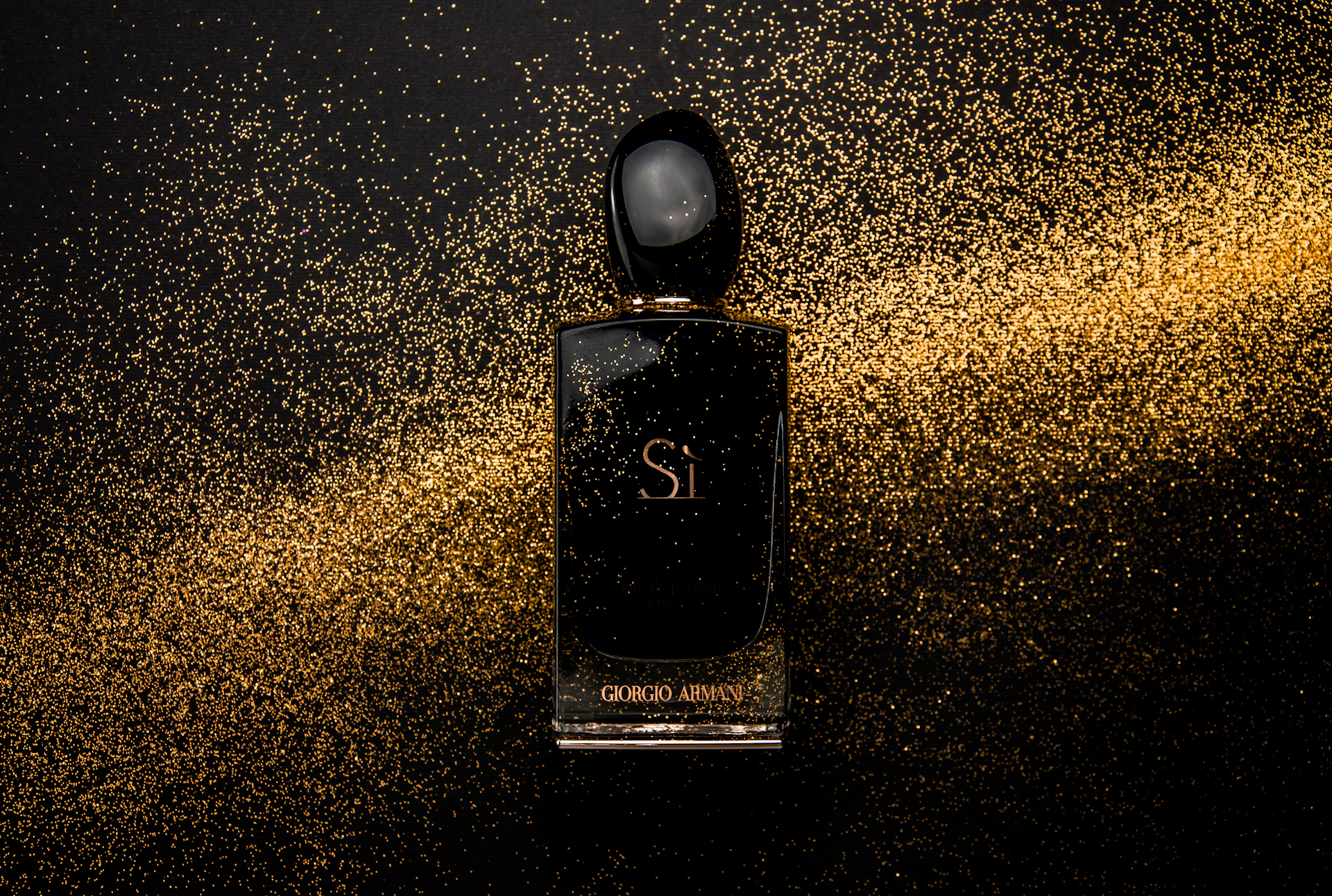 black glass perfume bottle showing front label