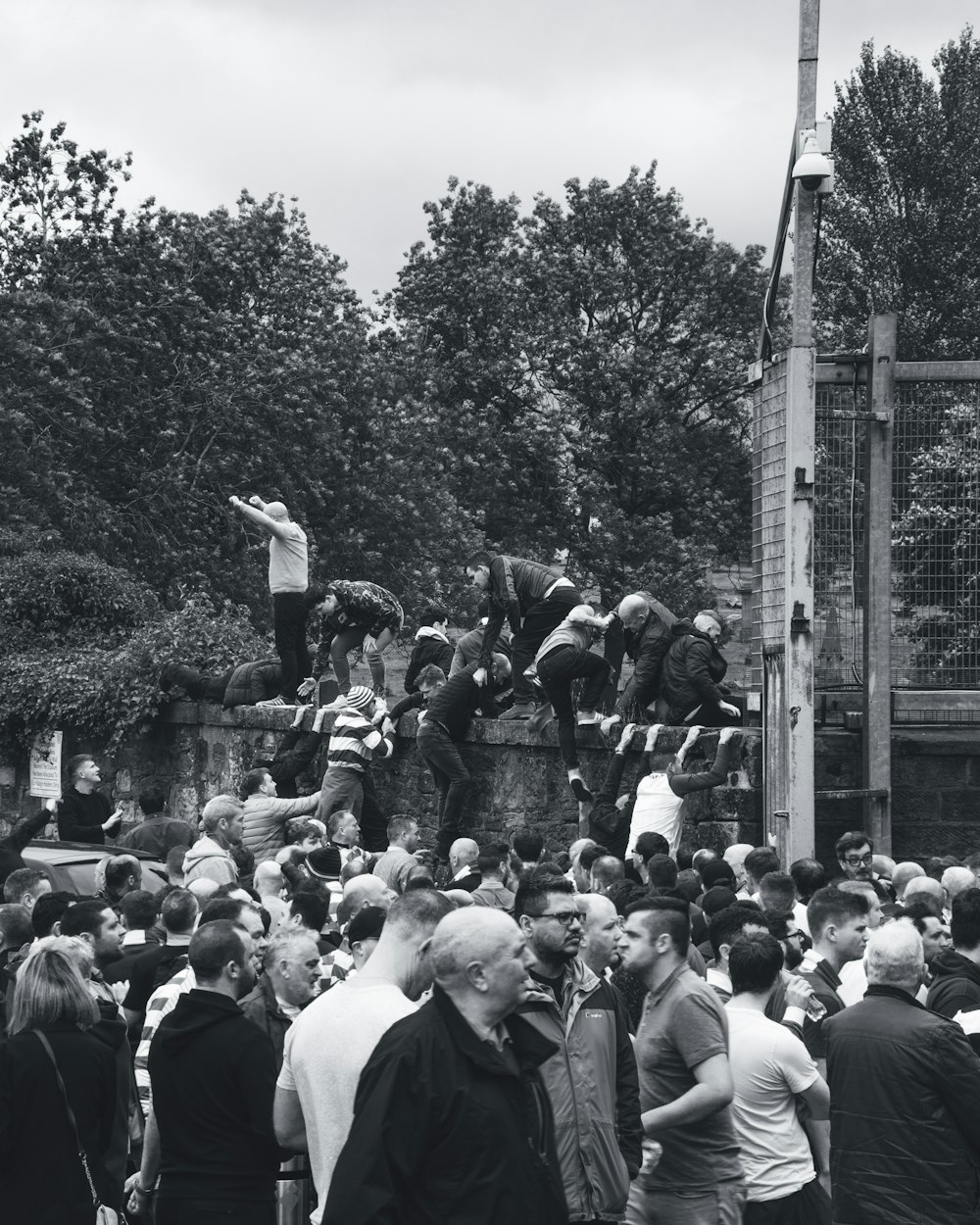 grayscale photography of people gathering