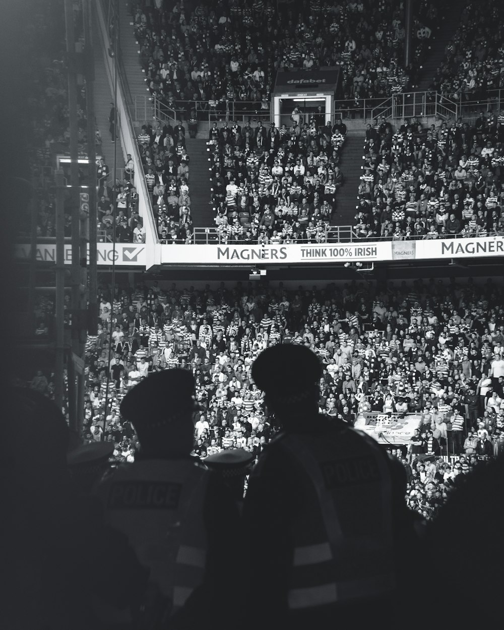 grayscale photo of men in stadium