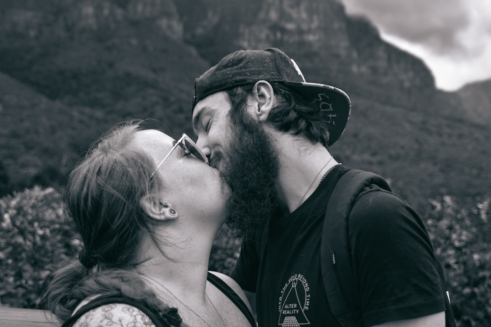grayscale photography of man kissing woman