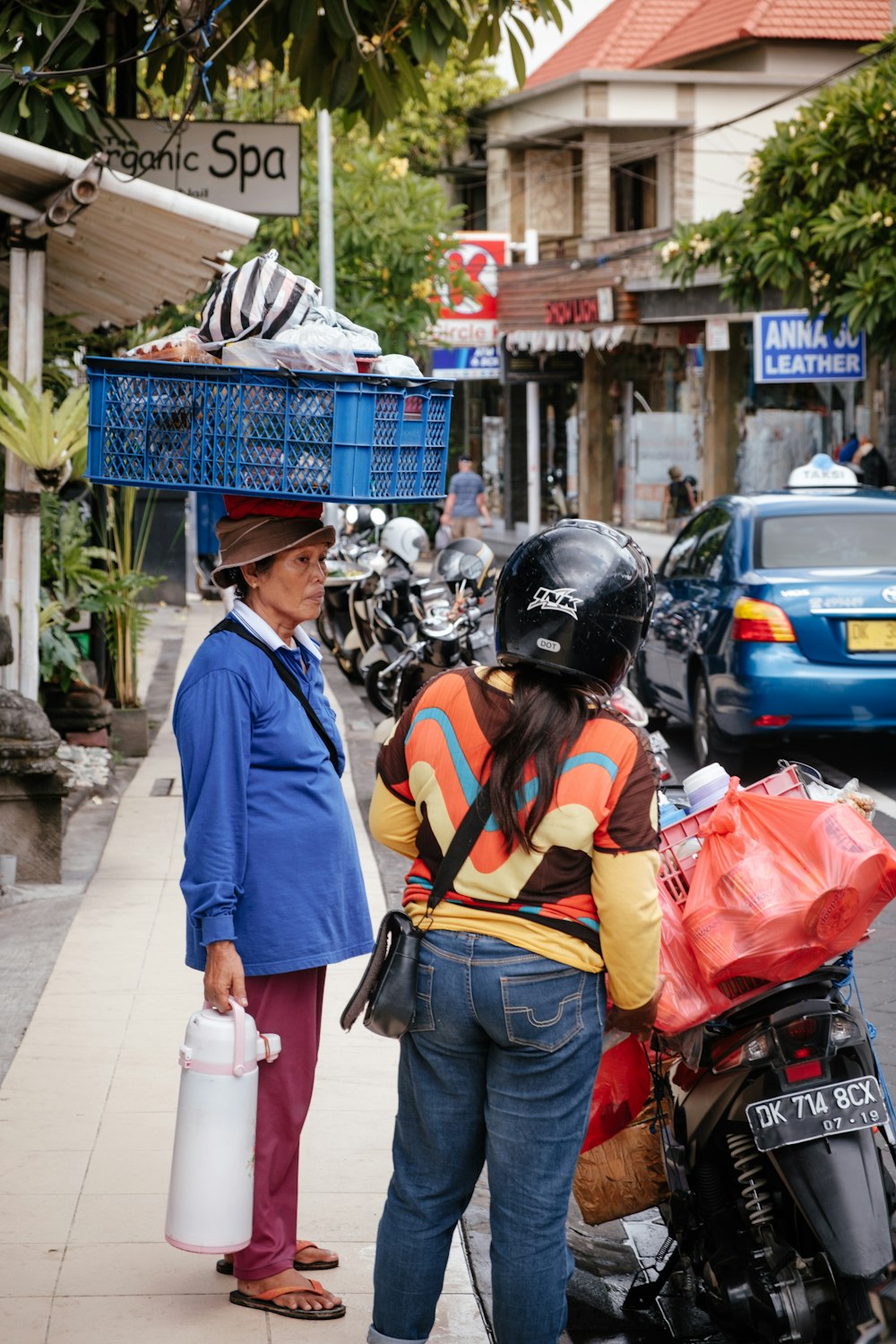 woman carrying blue basket on head