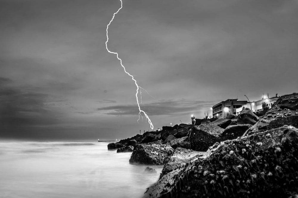 grayscale photography of house under thunder