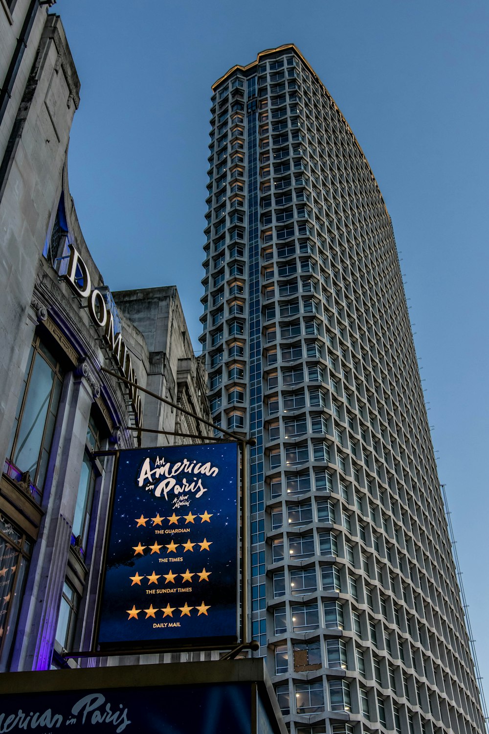 low-angle photography of American Paris sign during daytime