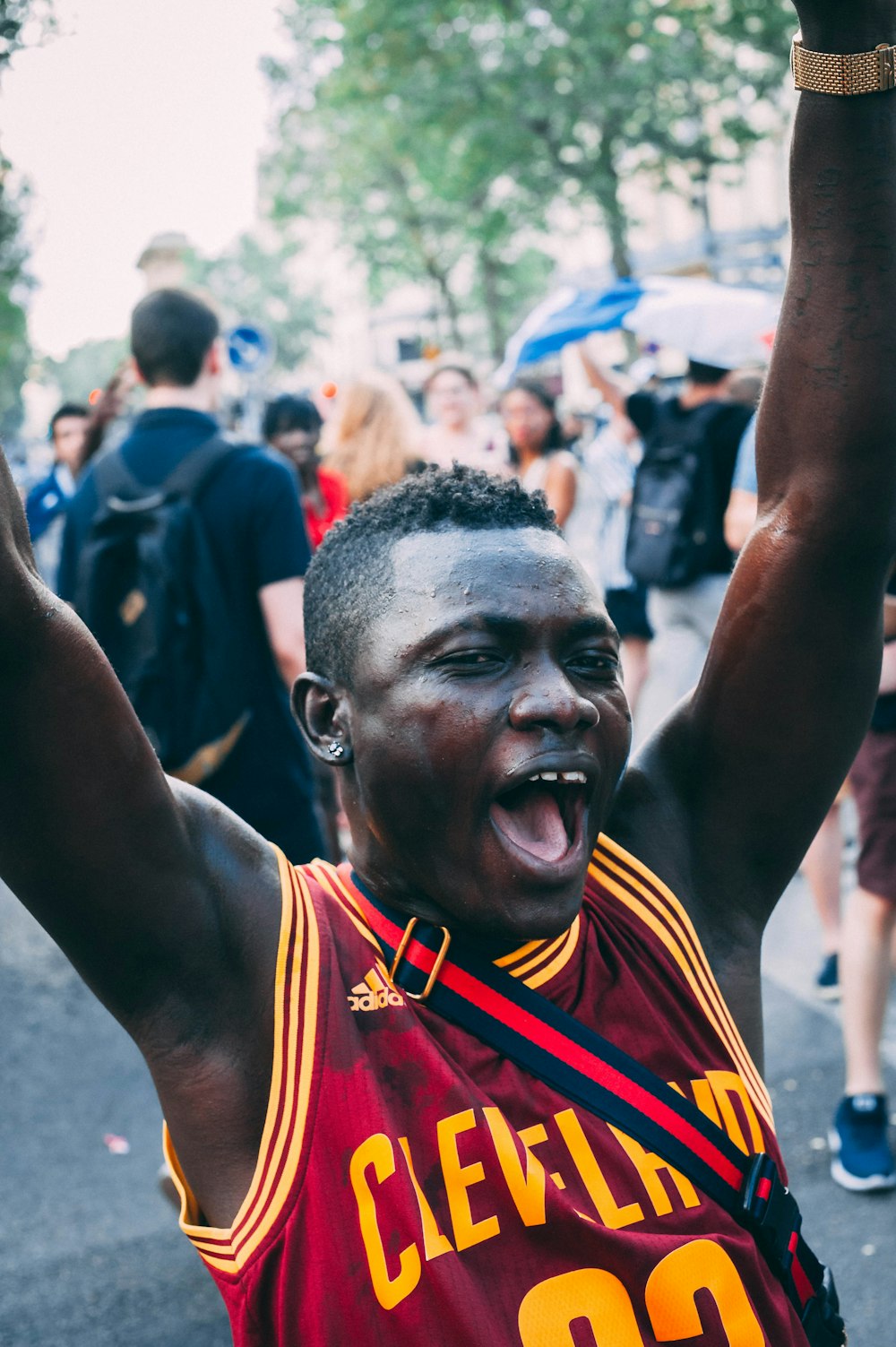 man in red Adidas Cleveland jersey raising hands