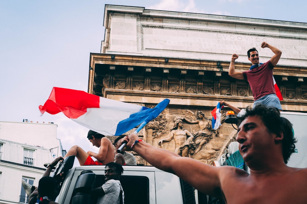 man wearing flag near truck during daytime