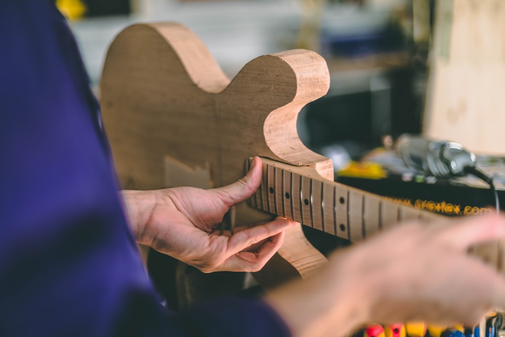 brown wooden guitar shape decor