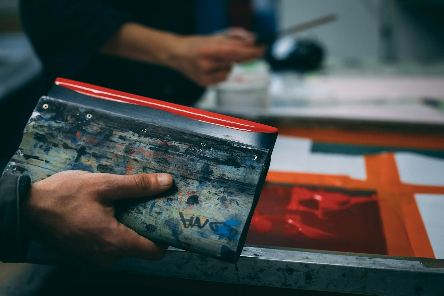 Screen printed t-shirts in various colors showing the same bold design
