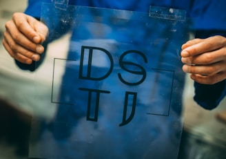 person holding DSTI plastic frame