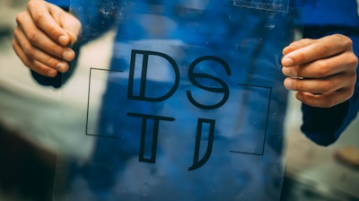 person holding DSTI plastic frame