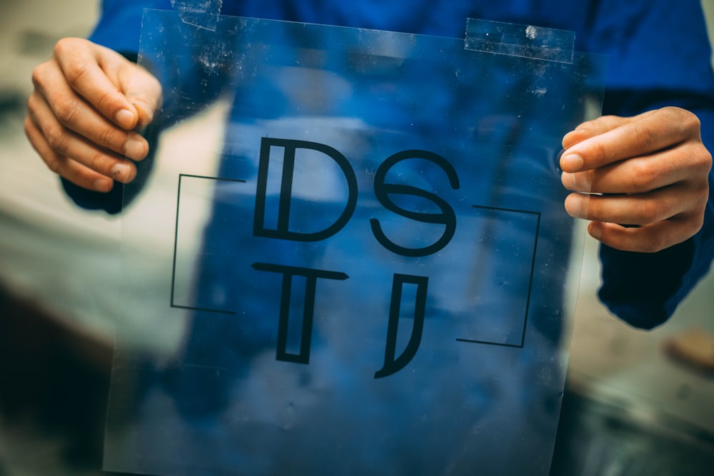 person holding DSTI plastic frame