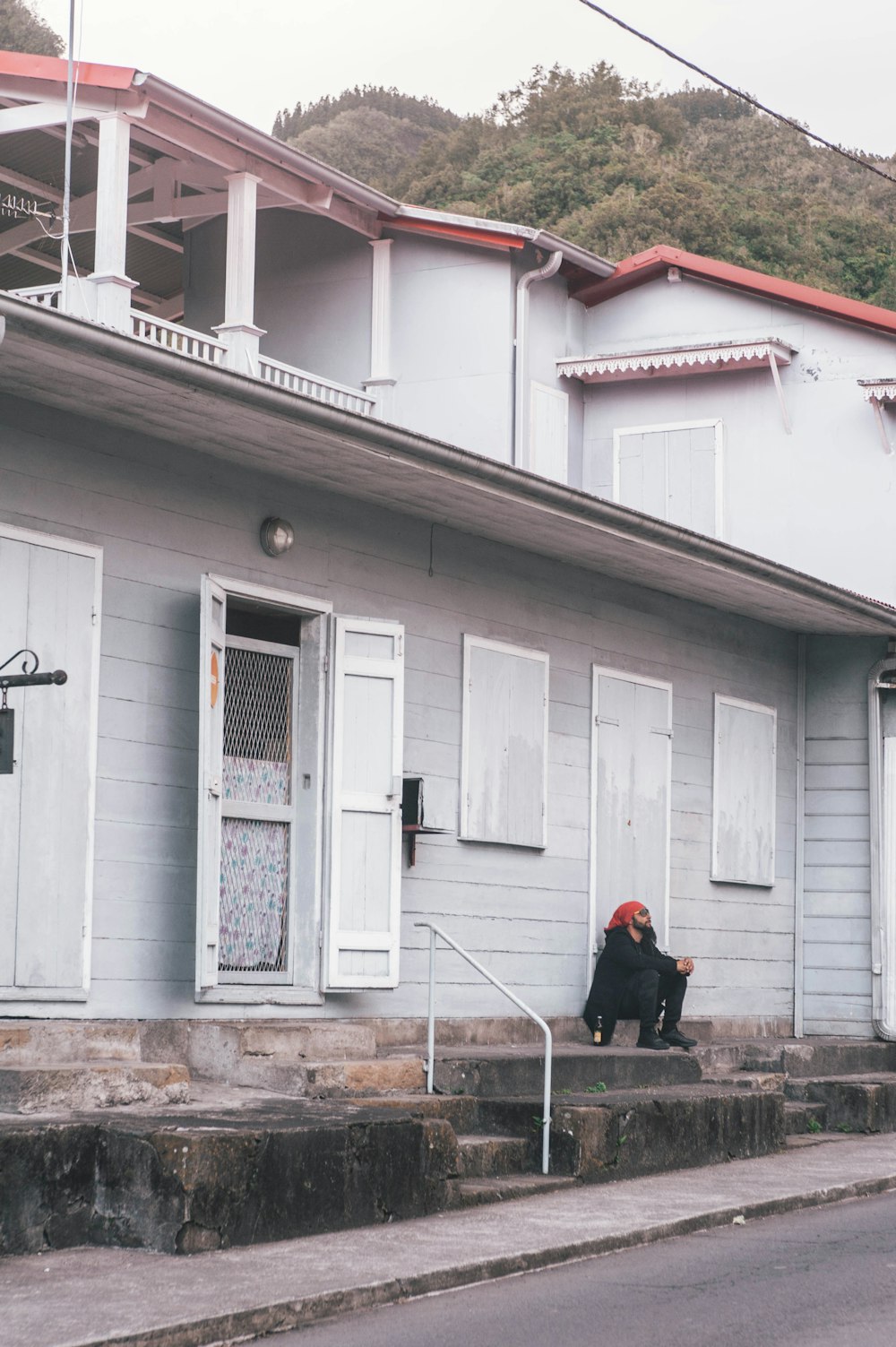 man sitting near white door