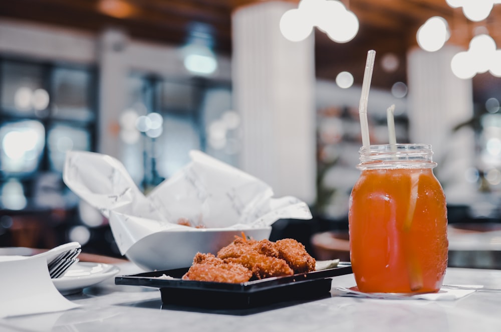 fried chicken and juice in glass jar
