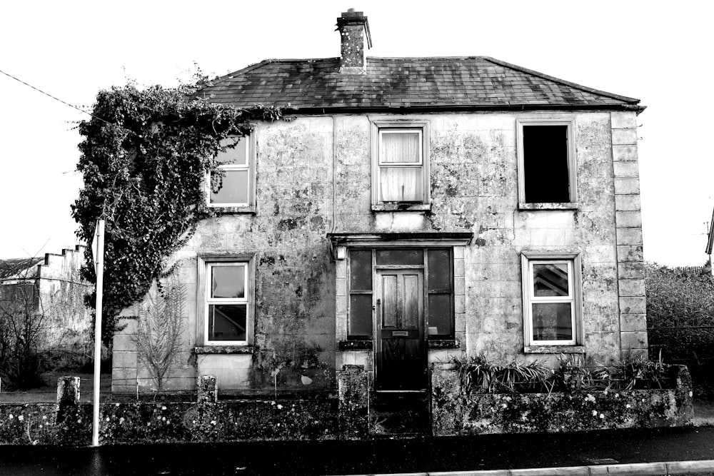 greyscale photo of white concrete house during daytime