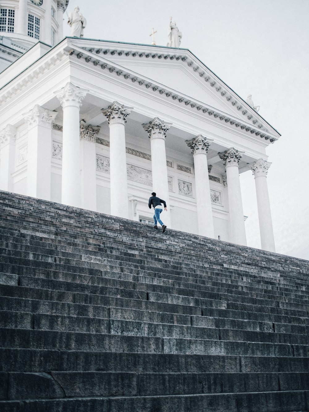 person running near the white concrete building