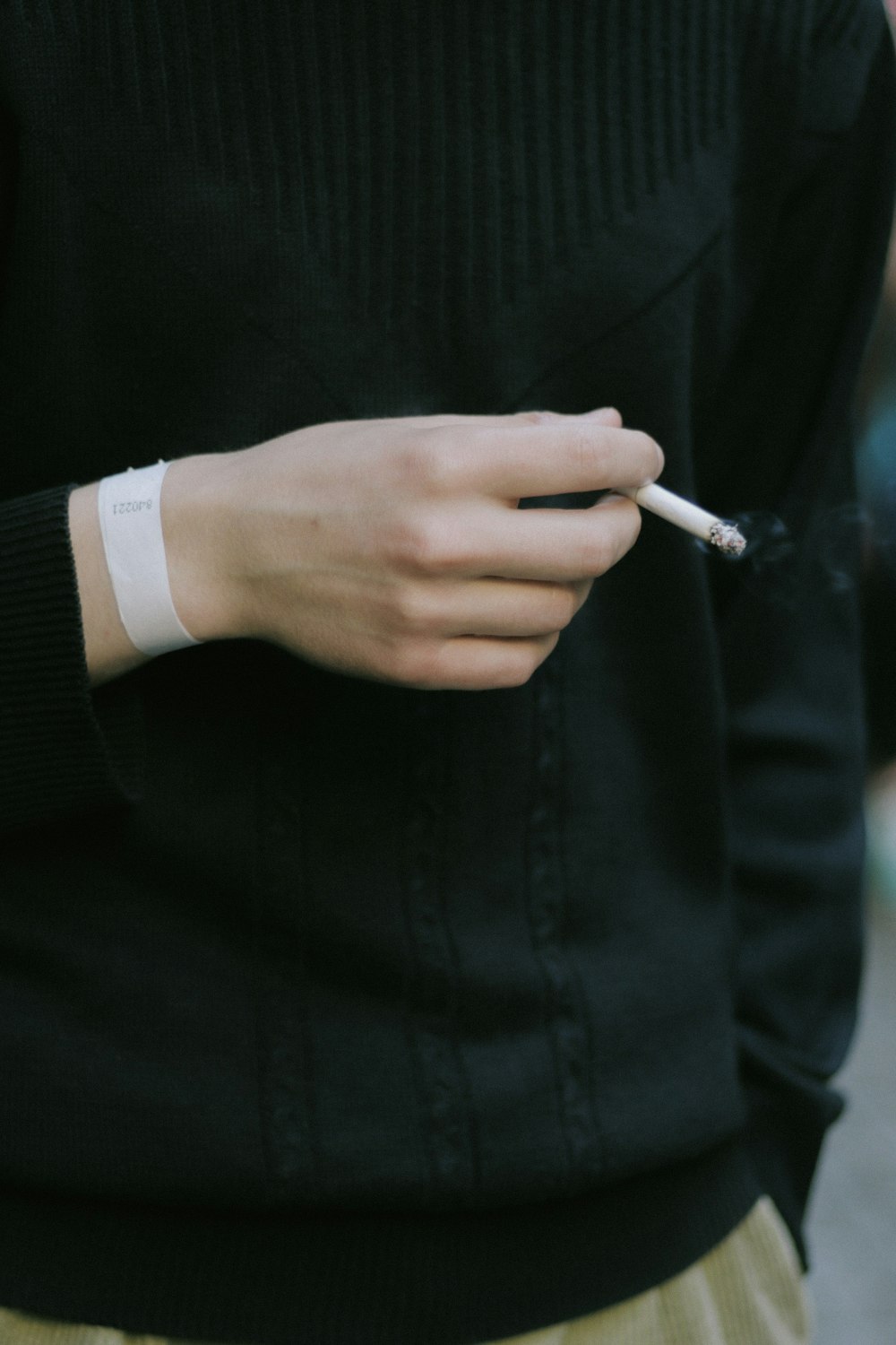 person holding cigarette
