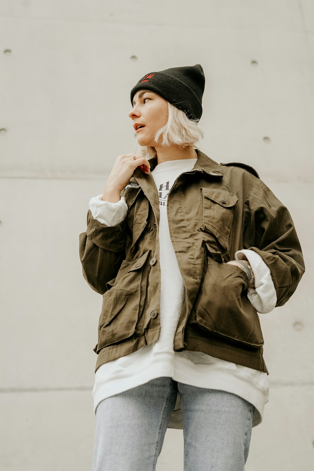 woman in brown jacket with white inner shirt and blue denim jeans