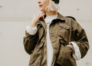 woman in brown jacket with white inner shirt and blue denim jeans