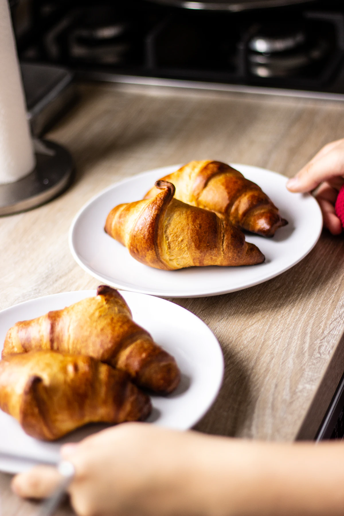 Freshly baked croissants and French pastries displayed in a Paris patisserie window