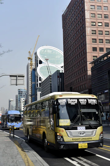 A vibrant cityscape with travelers boarding a sleek airport shuttle bus.