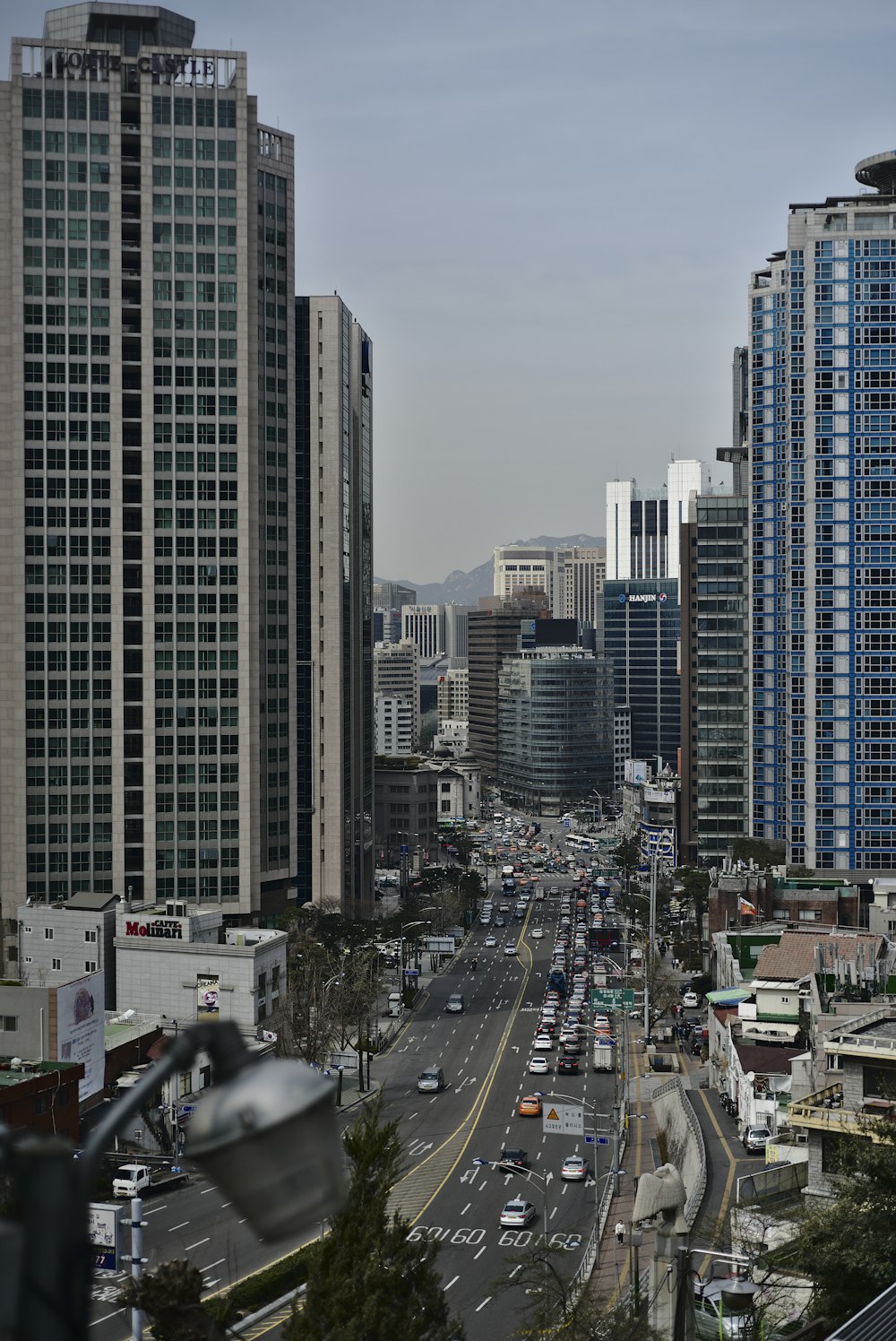 high-angle photography of cars on highway between buildings