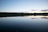 A calm lake reflecting a clear sky, evoking peace and clarity.