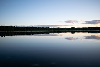 A close-up of a calm lake reflecting the sky.
