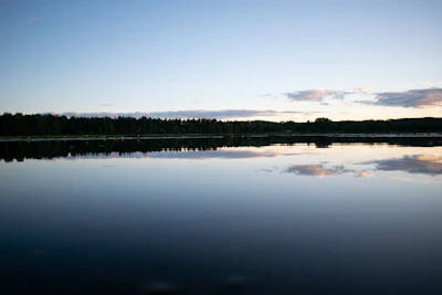 A calm lake reflecting a clear sky, evoking peace and clarity.