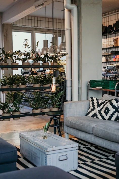 A sleek industrial iron side table with a rustic finish in a cozy living room.