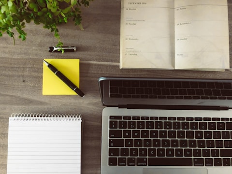 A close-up of a planner and laptop on a desk, symbolizing organization and productivity.
