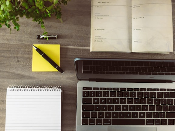 Close-up of a colorful digital planner opened on a laptop with neatly organized tasks.