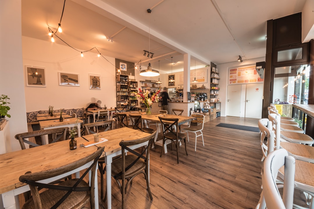 wooden tables and chairs inside white room