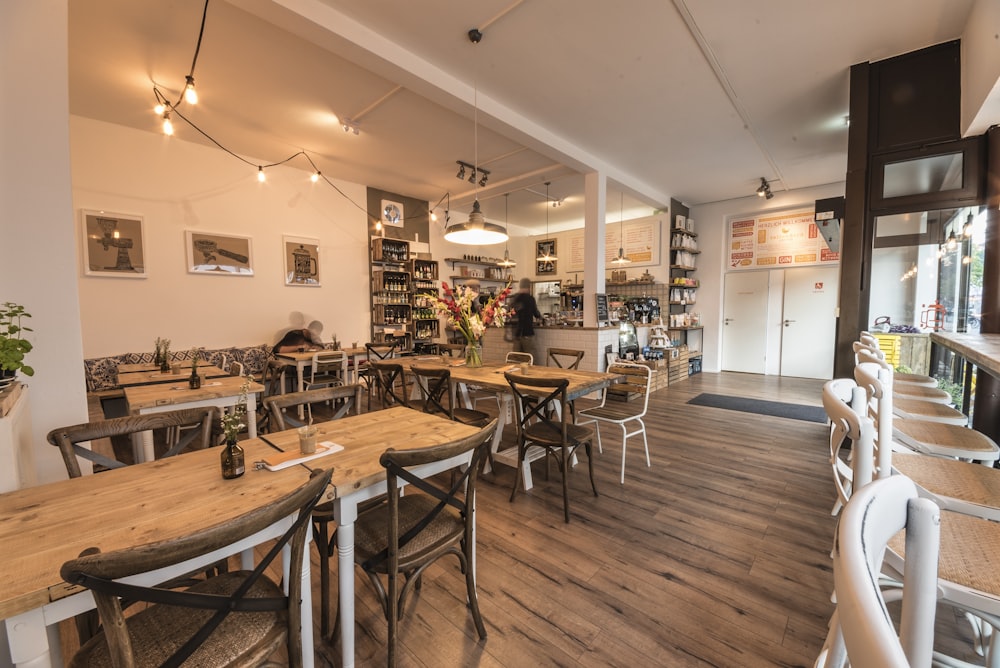 wooden tables and chairs inside white room