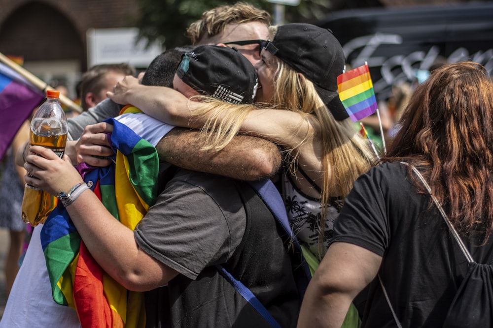 people hugging each other in the middle of crowd