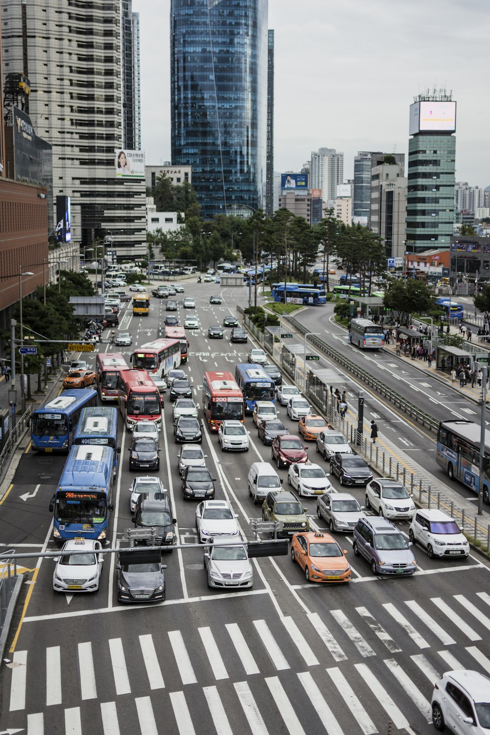 cars on road surrounded by buildings during daytime