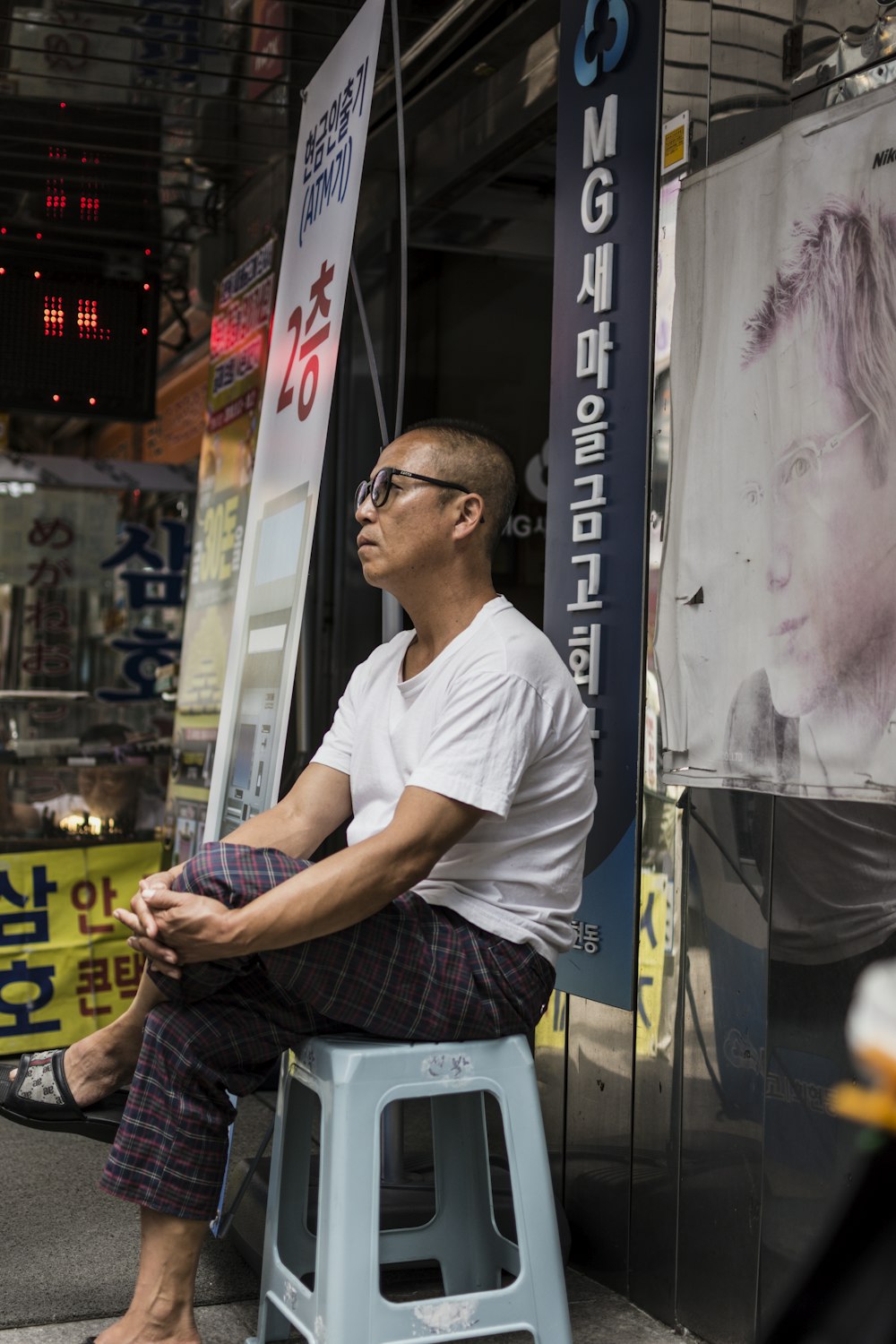 man wearing white shirt while sitting on chair