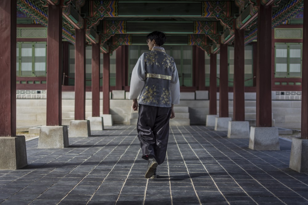 man walking under the building