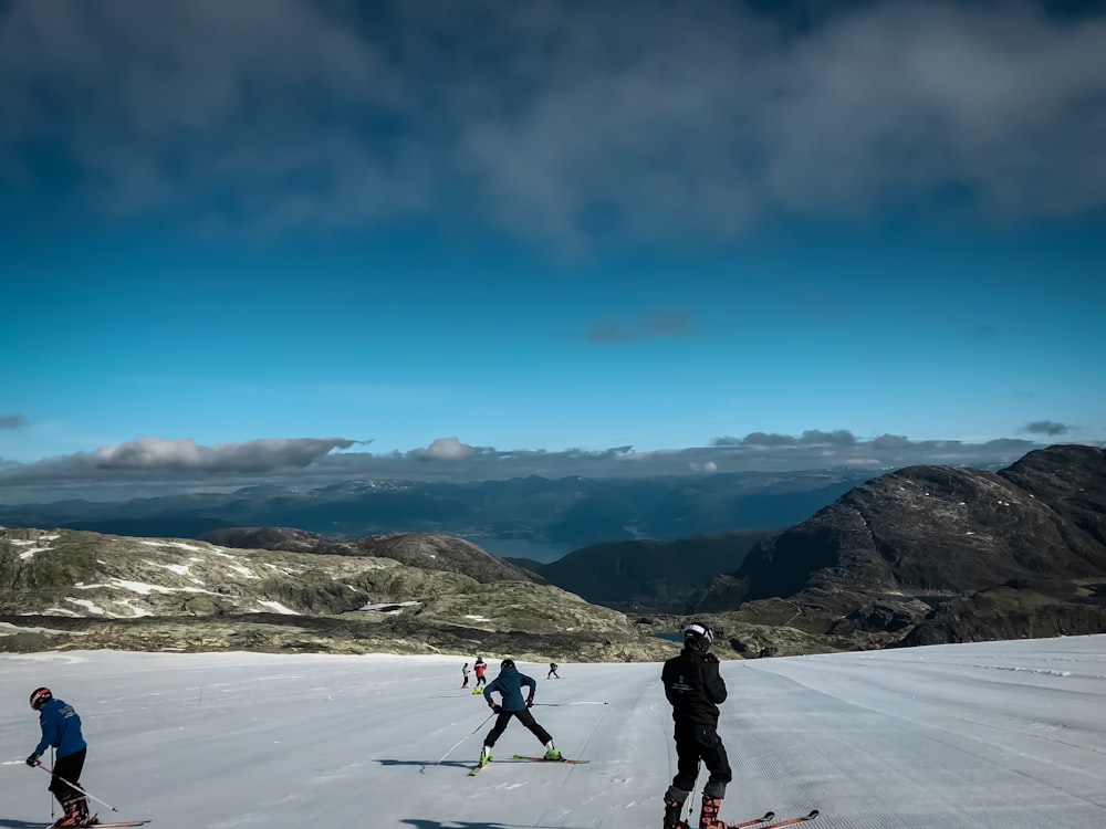 people skiing in snow covered slopes