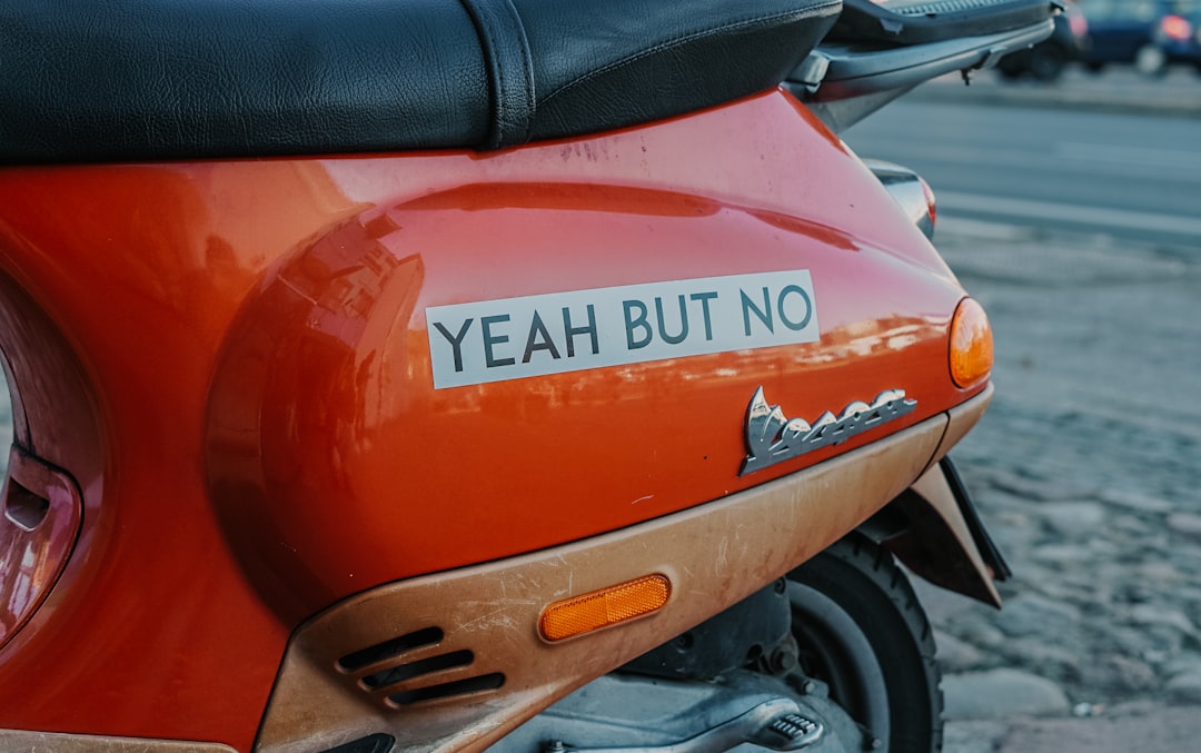 close-up photography of red motor scooter