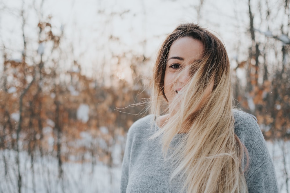 woman in gray crew-neck sweater