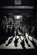 greyscale photo of crowd crossing road