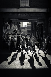 greyscale photo of crowd crossing road