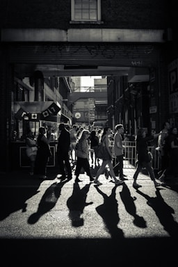 street photography,how to photograph abbey road style; greyscale photo of crowd crossing road