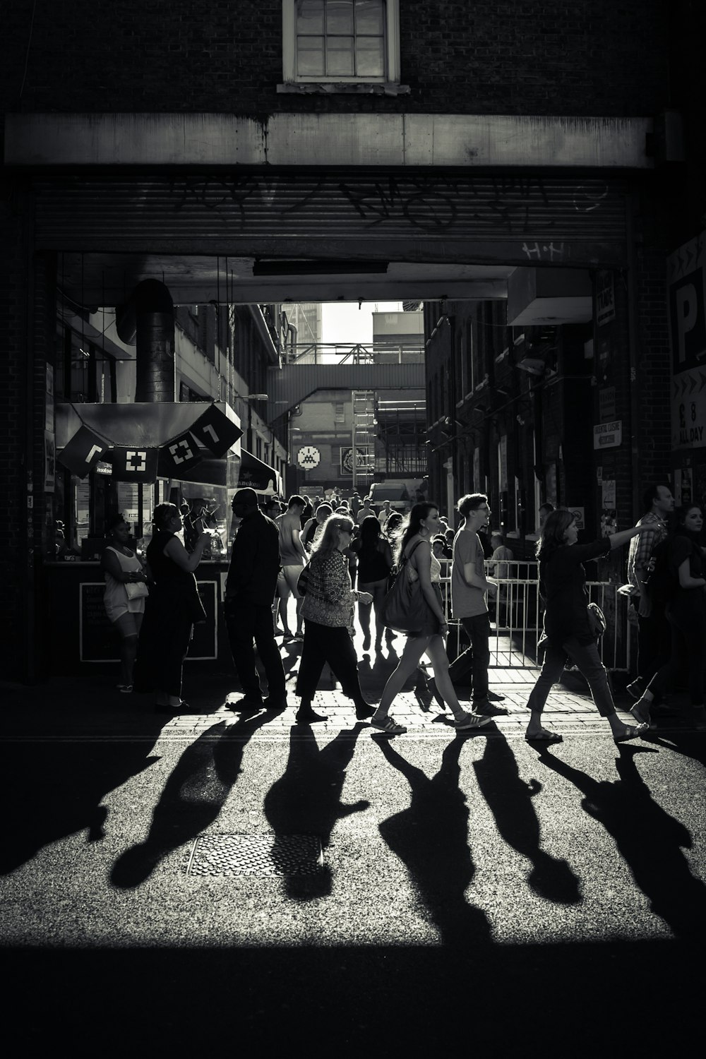 greyscale photo of crowd crossing road