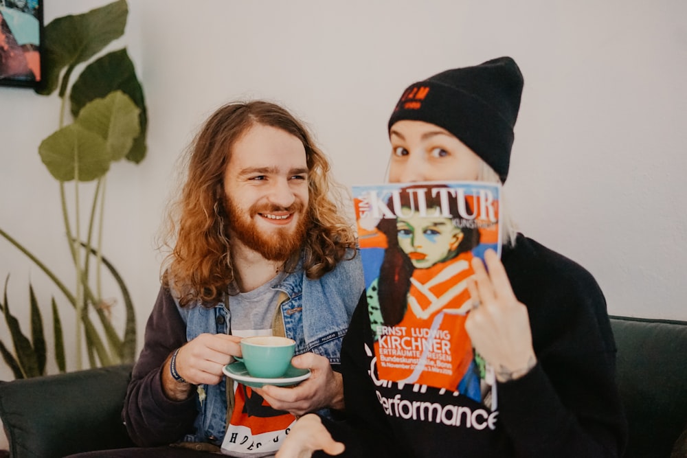 two person sitting on black sofa