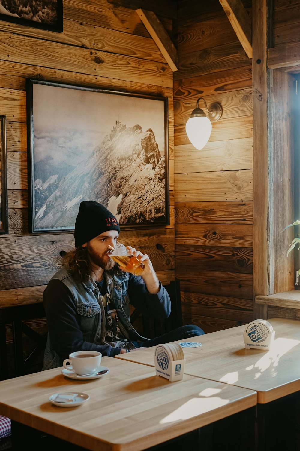 man drinks beer inside restaurant